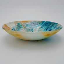 Blue and amber coloured fused glass bowl, with bands of white flow design, 23cm wide.
