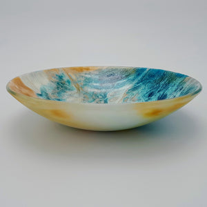 Blue and amber coloured fused glass bowl, with bands of white flow design, 23cm wide.