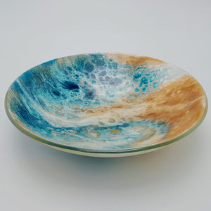Blue and amber coloured fused glass bowl, with bands of white flow design, 23cm wide. 