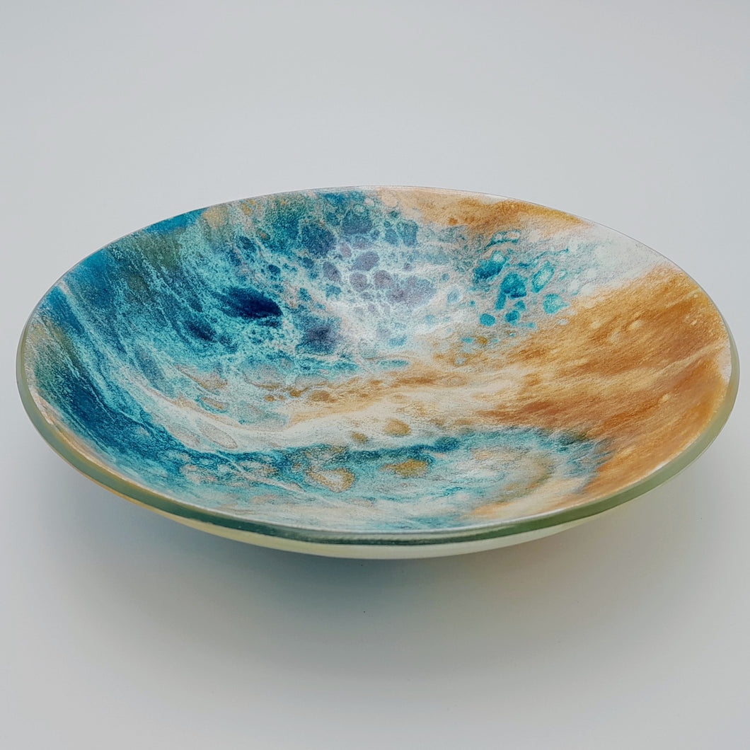 Blue and amber coloured fused glass bowl, with bands of white flow design, 23cm wide. 